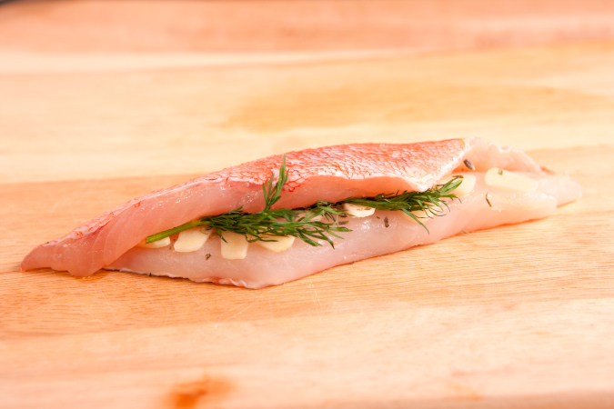 Two redfish fillets with garlic and herbs